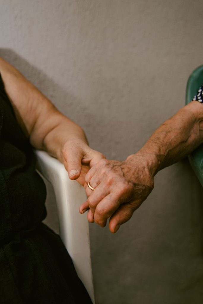 pexels-photo-36546935 Close-up of elderly couple's hands clasped, representing love and companionship.